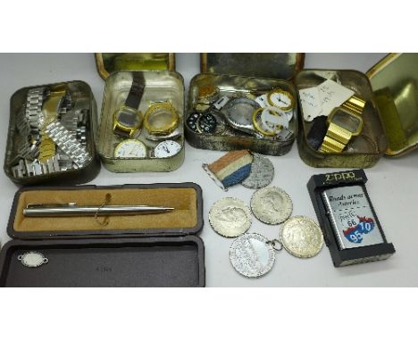 Watch parts, medallions, a lighter and a pen