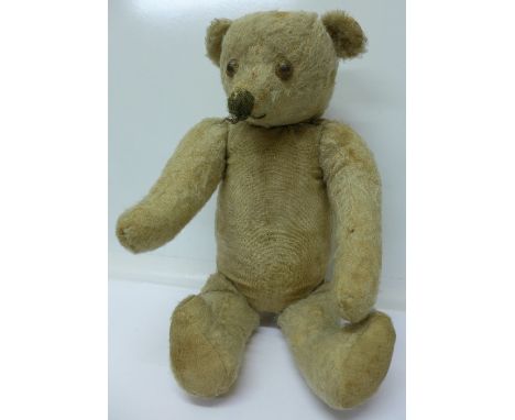 A straw filled jointed Teddy bear