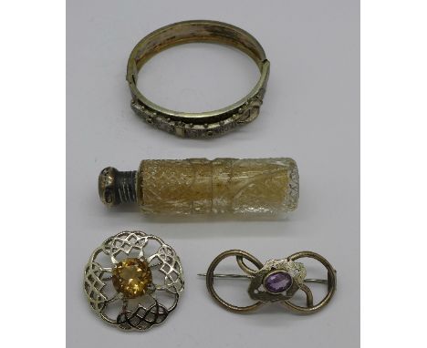 A silver topped scent bottle, two brooches and a bangle