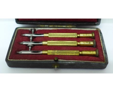 A cased set of three watchmaker's tools, each tool 7.5cm long