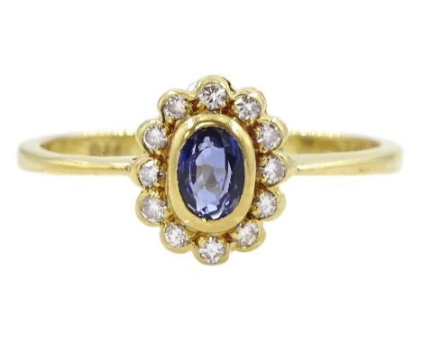 18ct gold oval sapphire and round brilliant cut diamond cluster ring, London 1986Condition Report:Approx 2.5gm, size Q, well 