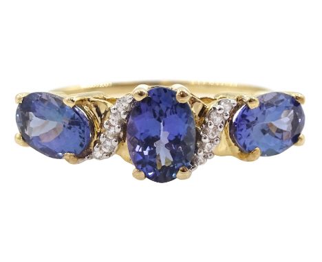 9ct gold three stone oval tanzanite ring, with diamond accents, hallmarked Condition Report:Approx 2.2gm, size Q-R, well pres