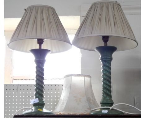 A pair of green painted twist stem table lamps with shades, together with a cream silk damask lamp shade with tassels. (3) 