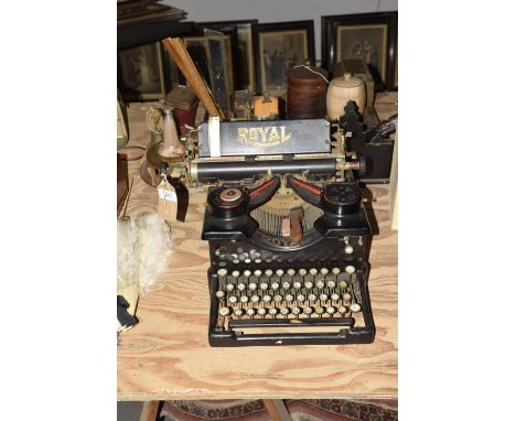 A vintage Royal typewriterOf typical form with dual red and black ink tape, along with typewriter key brush and two erasers. 