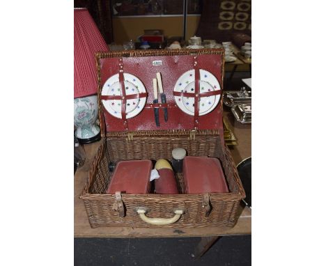 A vintage wicker Sirram picnic basketThe wicker basket contains four plates, three saucers - both Victoria & Trentham Potteri