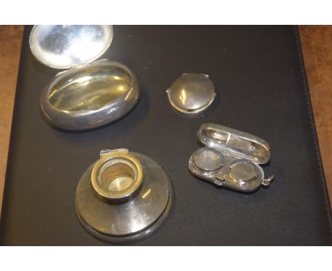 A hallmarked silver oval hinged boxAlong with a weighted silver Capstan ink well, and an oval silver cased sovereign case. (3
