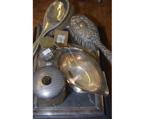 A collection of silver and white metal itemsTo include a glass dressing table tray within a silver border raised on bun feet,