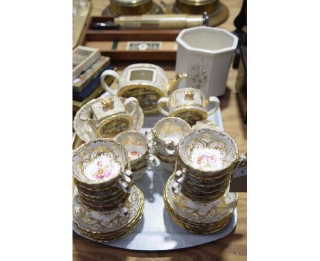 A tea service, 20th Century To include 12 breakfast cups, seven teacups, 12 plates and a fruit bowl all picked out with gilt 