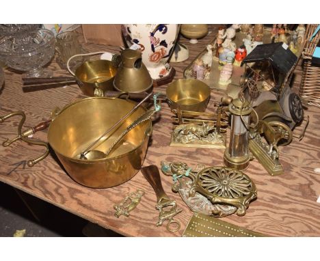 A collection of various brass metal waresTo include a brass jam skillet, two brass milk pans, a brass candle lamp, a brass ca