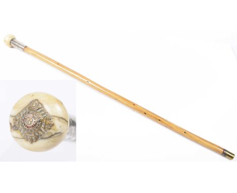 A military swagger stick, early 20th CenturyThe 67cm long bamboo and silver mounted swagger stick with ivory pommel with inse