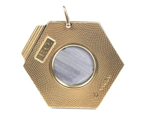 A 9ct gold cigar cutterOf hexagonal form, the engine turned frame with rectangular cartouche bearing the initials F.O., and a