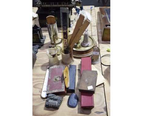 A large group of collectible itemsTo include two sliding scientific rulers, a cigarette tin with apothecary weights within, a