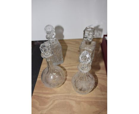 A group of four cut glass decantersThe first of rectangular form with silver collar, another similar along with two bulbous f