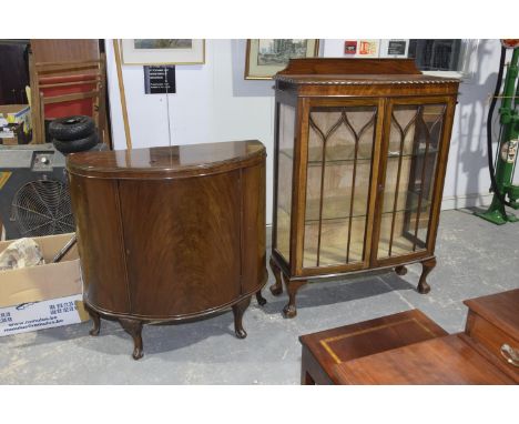 An early 19th Century mahogany bow front display cabinetHaving a gadroon border above two astragal glazed doors enclosing two