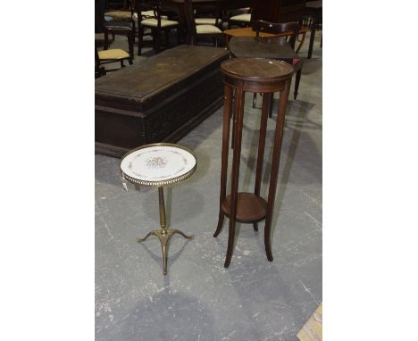 An Edwardian mahogany plant stand and a brass wine tableThe Edwardian plant stand with two circular tiers on legs of tapering