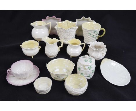 A collection of Belleek ceramicsTo include three various jugs 9cm, 7.5cm and 9cm, a twin handled sugar bowl, a tea cup decora