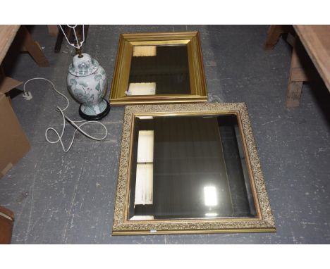 Two contemporary wall mirrorsThe first wall mirror within a carved in high relief gilt frame (64cm x 71cm) and the second wal