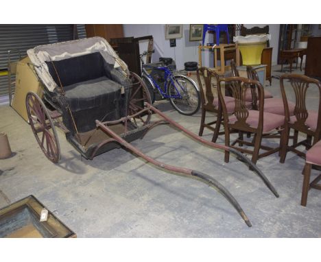 A rare single axle pony carriage, c.1900The wicker carriage body beneath a folding canvas canopy mounted on a single axle wit