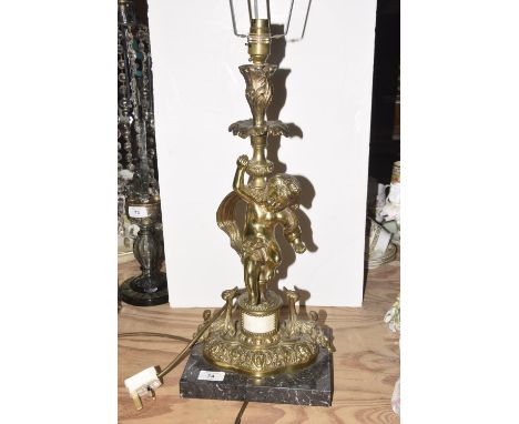 A gilt metal figural table lamp, 20th CenturyThe figural lamp modeled with a cherub upon an ornate gilt stand, raised upon a 