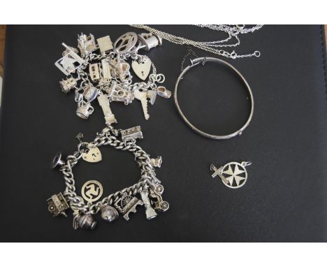 A selection of silver and white metal jewelleryTo include two charm bracelets, a bangle, pendant etc, weight approx. 4.6oz. 