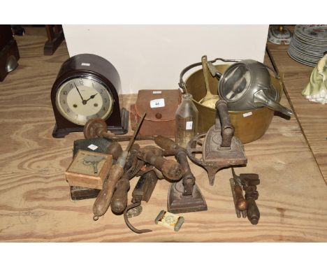 A mixed group of metal waresTo include a brass jam skillet, a pewter teapot, two flat irons, a Pyrex babies bottle, two woode