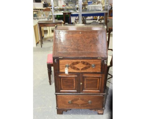 A 19th Century mahogany bureauThe rectangular top with an openwork brass galleryabove a fall front and an arrangement of two 