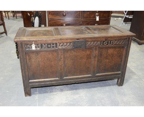 A 17th Century oak cofferHaving an inverted moulded three panel top above a frieze carved with an intertwined geometric desig