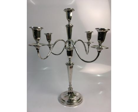 A silver five light candelabra with four twisting arms, dated 1907, height 48cm, approx. weight 1.7kg. Online viewing and bid