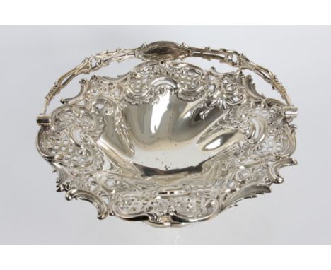 A Victorian silver basket of decorative form with loop handle with marks for Sheffield 1839 and Henry Wilkinson &amp; Co. Onl