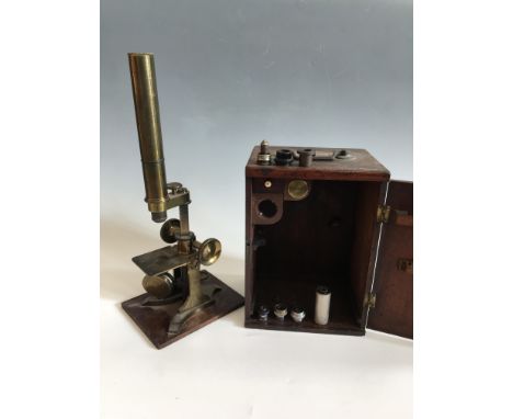 A microscope on wooden base in wooden box with additional lenses and other parts. IMPORTANT: Online viewing and bidding only.