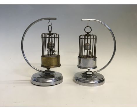 Two bird cage automaton clocks hanging on suspended stand. IMPORTANT: Online viewing and bidding only. No in person collectio