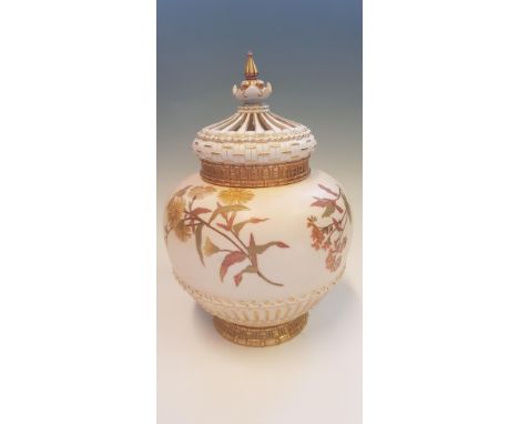 A Royal Worcester lidded pot pourri pot, model no. 1286, decorated with gilding and sprays of country flowers on a blush grou