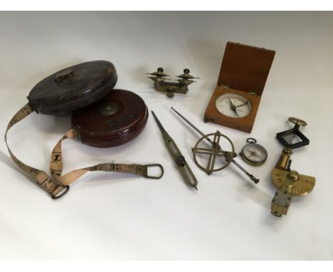 A selection of various tools including two leather cased tape measures, proportional dividers, small Stesco compass, Palmer P