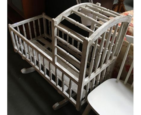 A white painted vintage rocking cradle 