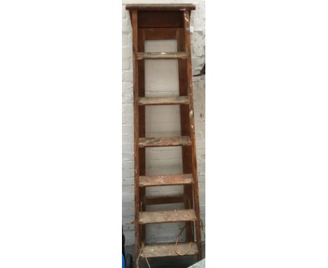 A tall vintage wooden step ladder 
