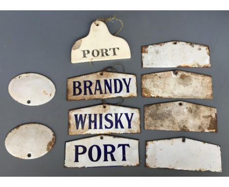 A collection of enamel barrel labels for whiskey, brandy, and port, six more unmarked, and one ceramic for port 