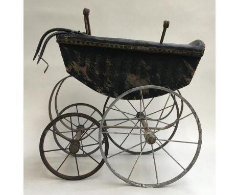A late 19th century doll's pram, wrought iron and wood, with ceramic handle 