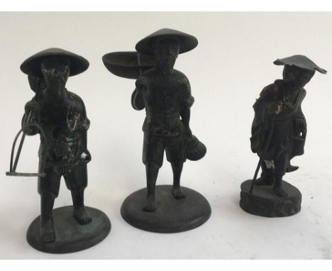 Three Vietnamese bronze figures of agricultural workers 