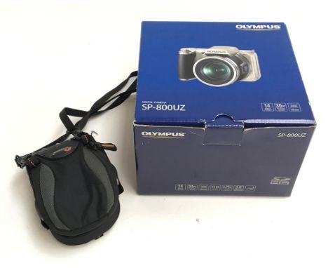 An Olympus SP-800UZ 14MP digital camera, in original box, together with a Casio Exilim 5MP digital camera, and a Panasonic Lu