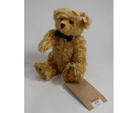 A modern Steiff The Royal Crown Derby Steiff bear, in dark blond with button to ear and white label numbered 61464,further nu