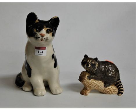 A Winstanley model of a seated cat, height 22cm, together with a Beswick model of a raccoon model No. 2194 (2)