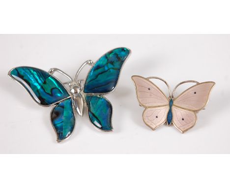A continental silver gilt and enamel set butterfly brooch; together with a paste example (2).Smaller example – bar slightly b