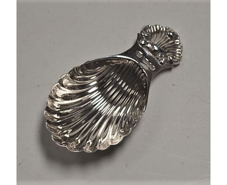 A modern silvered caddy spoon in the Georgian style, having shell shaped bowl with shell cast terminal