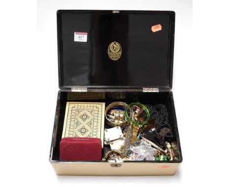 A lacquered box and contents to include niello style bangle and various brooches etc