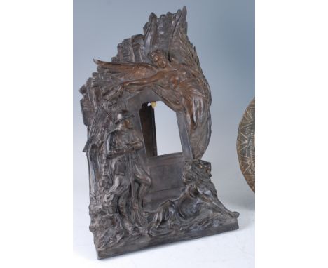 An Art Deco patinated bronzed metal easel photograph frame, of good size, embossed decorated with an angel, a standing soldie