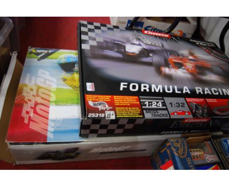 A Scalextric Moto GP World Championship box set, together with a Carerra Evolution Formula racing Scalextric style set