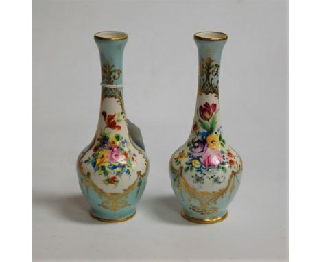 A pair of Paris porcelain bottle vases, enamel decorated with floral sprays within gilt borders