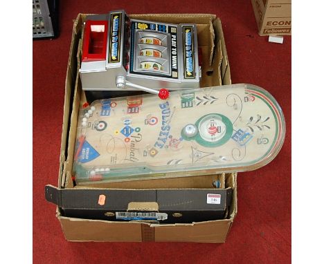 A collection of toys and games, to include a Bullseye Pinball game, table-top fruit machine, various clockwork tinplate toys 