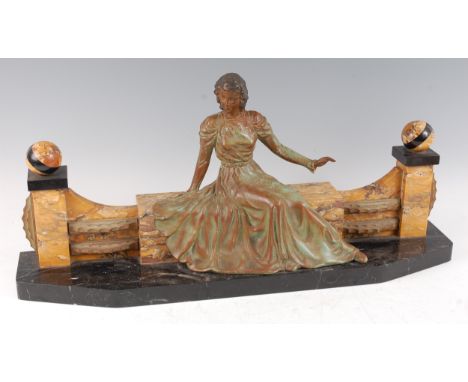 An Art Deco spelter and marble sculpture, of a lady in seated pose, wearing long flowing dress, raised on Siena and black mar