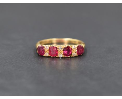 An 18ct gold diamond, ruby and red stone ring, the four cushion cut red stones interspersed with six diamond chips, one red s
